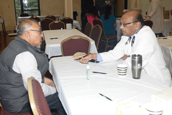 A local resident consults one-on-one with volunteer cardiologist