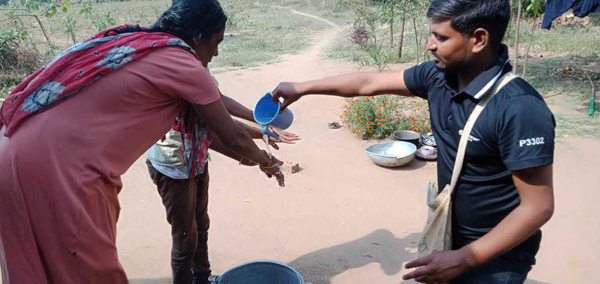Villagers practice hand washing to combat the spread of the virus.