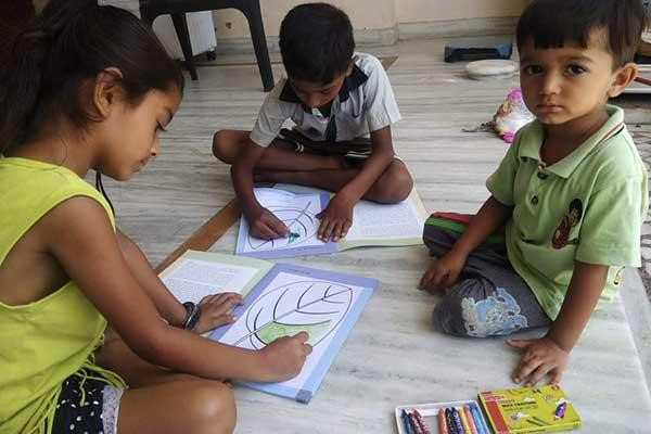 Young children with art kits supplied by village Lok Mitras.