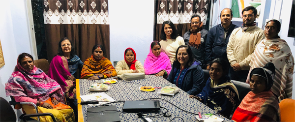 Share & Care’s Women’s Empowerment committee members sit down with women from Pradan self-help groups. Seated: Jayanti Devi, Jyotsna Shah (Share & Care), Jogini Devi, Kumari Reena, Saraswati Devi, Ketki Shah (Share & Care), Madina Khatoon, and Sangeeta Devi.