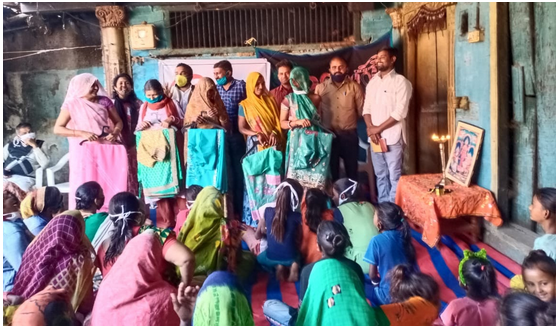 Volunteers and beneficiaries attend a sari library inauguration in Punadra Village. 