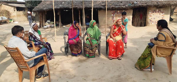 Women and volunteers gather in a Rural Women Livelihood Group.